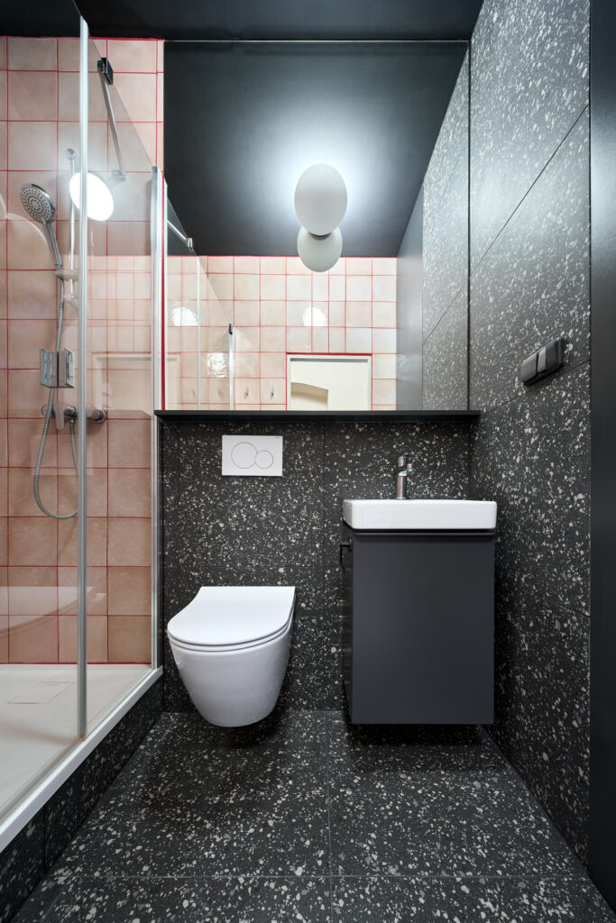 bathroom design with black red and pink tiles